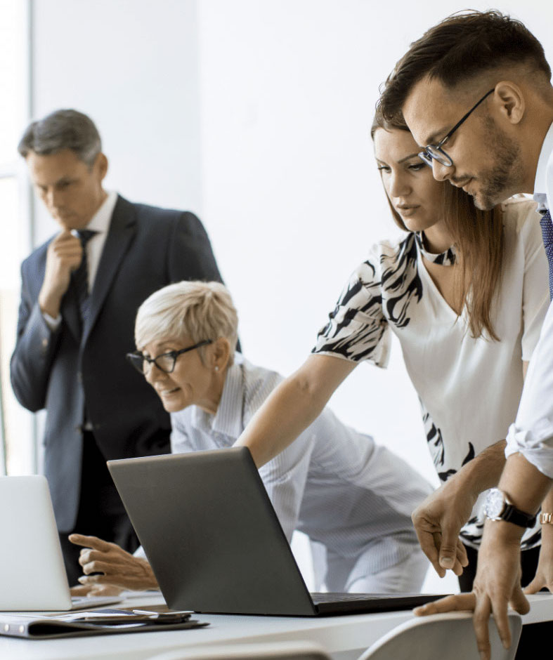 senior-businesswoman-working-together-with-young-business-people-office-4